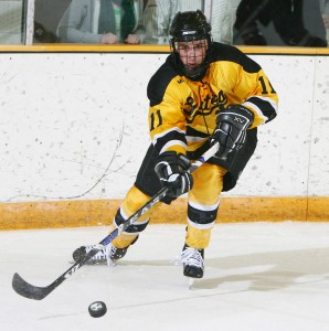 Senior forward Dave Martinson handles the puck during a home game last year. Sports Information.