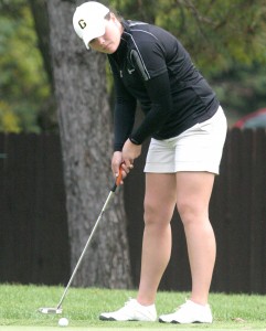 Junior Katie Schenfeld,. named co-MIAC Player of the Week, concentrates on a putt from the edge of the green. Sports Information.