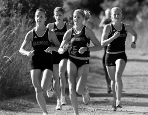 (Left to Right) Senior Vanessa Jones, Junior Megan Lundgren, Junior Brooke Beskau and Kelly Chaudoin ‘09 run together in a meet last year. Sports Information.