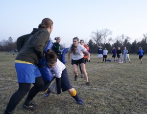 The Gustavus Women’s Rugby team runs a drill during practice. Jake Seamans.