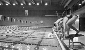 Gustavus Men’s and Women’s swimmers prepare to dive off the starting block during practice. Jake Seamans.