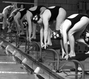 Gustavus Women’s swimmers prepare to dive off the block in a recent meet.  Sports Information.