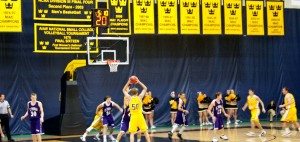 Gustavus’ Paul Blacklock holds the ball in St. Thomas’ zone during last Wednesday’s game. The Gusties came away victorious and are undefeated in the MIAC. Lindsay Lelivelt.