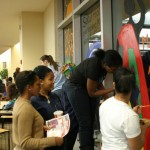 Members of the Pan Afrikan Student Organization (PASO) work together to decorate an Africa Night-themed window. Submitted
