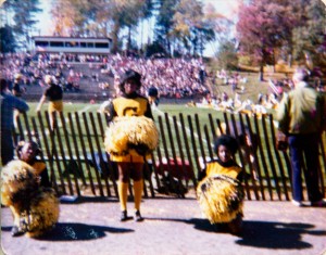 Gustavus cheerleaders cheer at a football game against St. Johns. Gustavus Adolphus College Archives