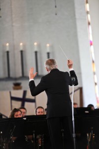 Doug- las Nimmo conducts the Gustavus Wind Orchestra.