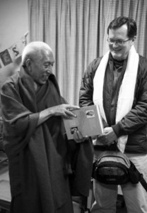 Curtin discusses a gift with former Prime Minister Venerable Samdhong Rinpoche. Submitted