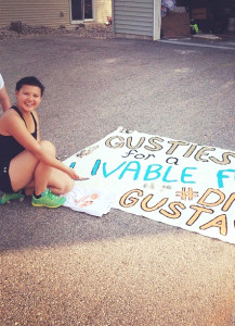 Junior Nicole Ektnitphong takes a break from painting a sign for Divest-Fest to pose for a picture. Submitted