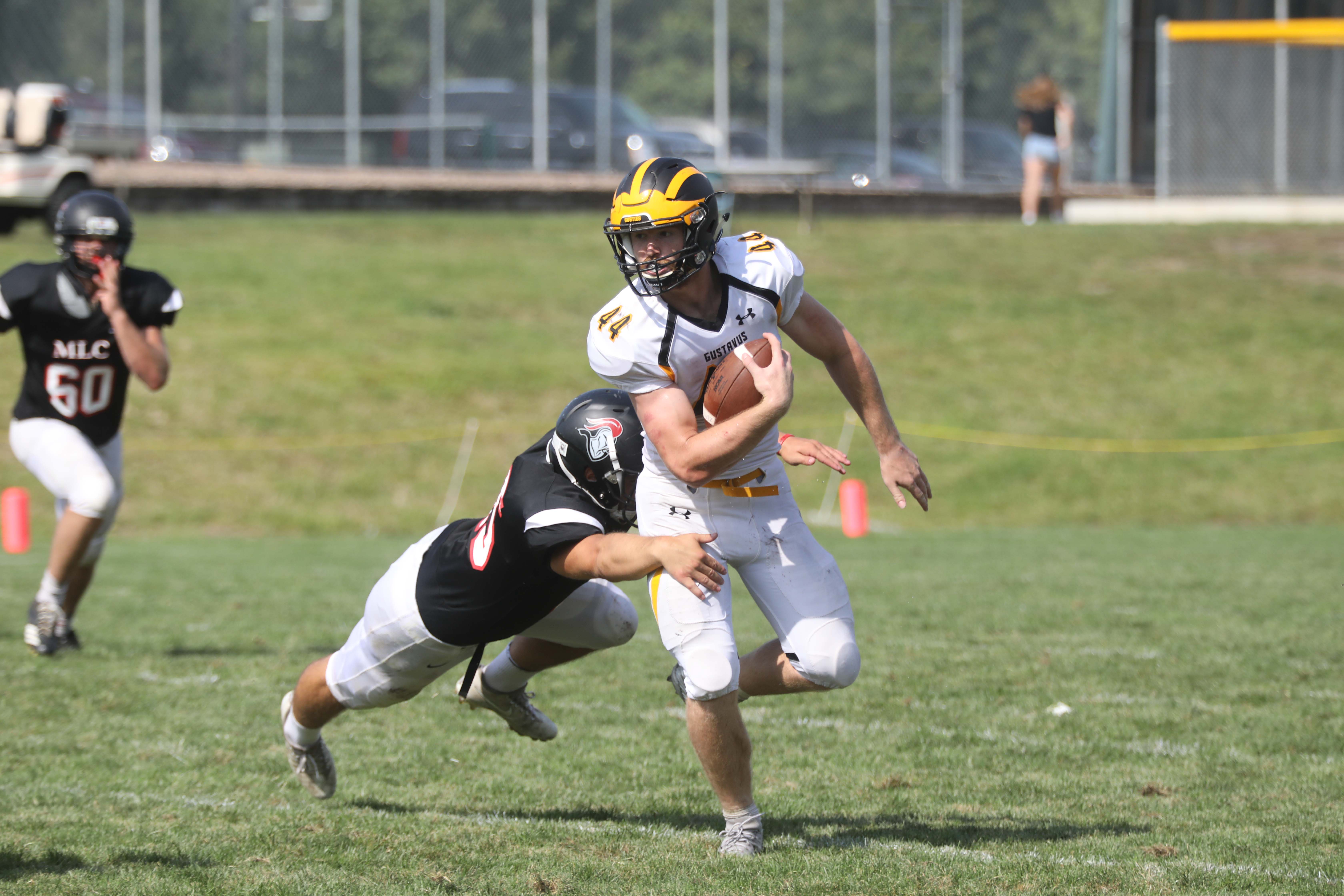 Junior Brayton Finch breaks a tackle during a game against Martin Luther. The Gusties won their first game with a score of 32-20. Finch completed a touchdown and had four receptions in the game.