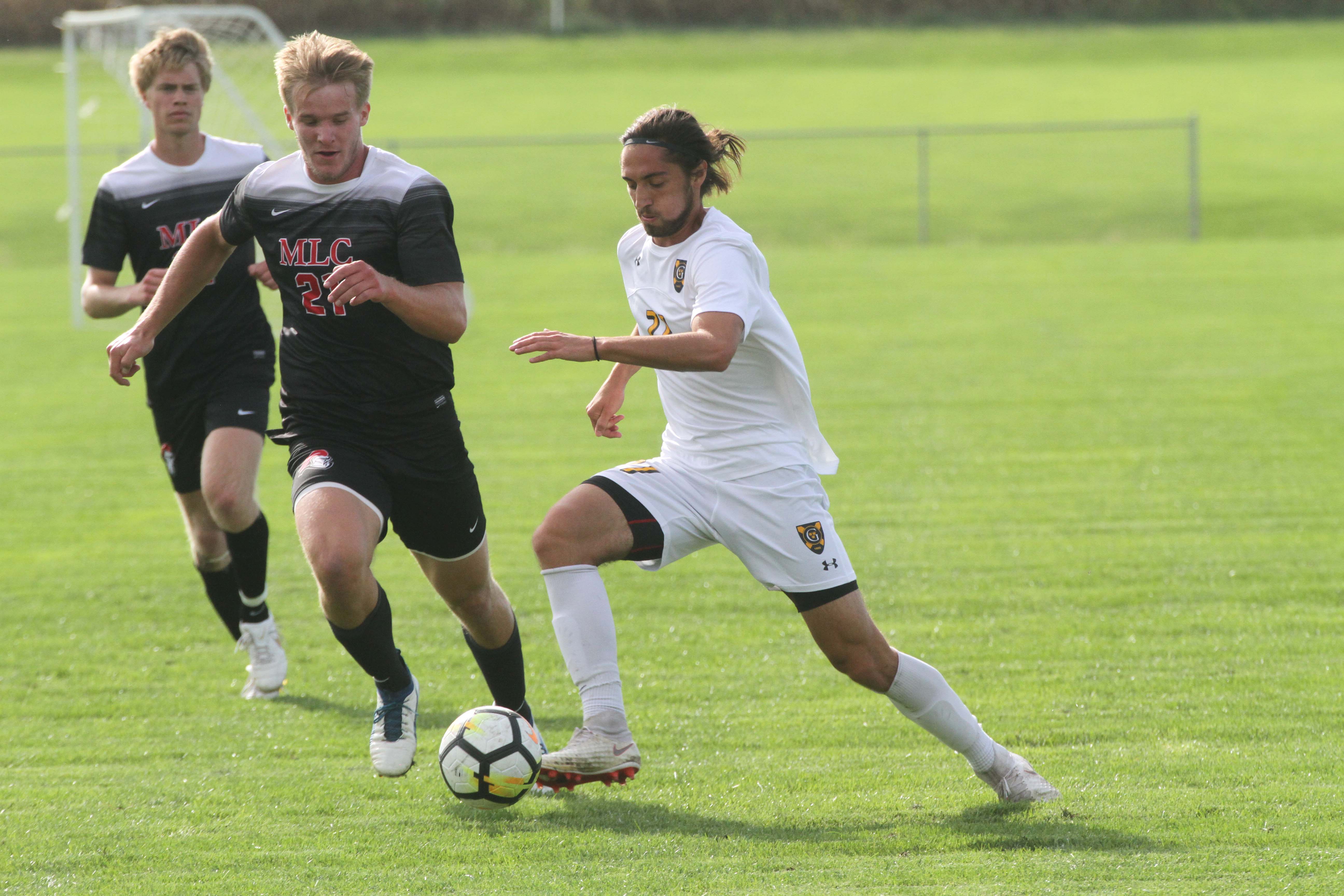 Junior Luke Laurich dribbles the ball past a Martin Luther midfielder.