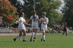 Members of the Gustavus Women’s soccer team celebrate a goal. The team currently holds a record of 5-7-1 and a record of 2-4-1 in the MIAC.