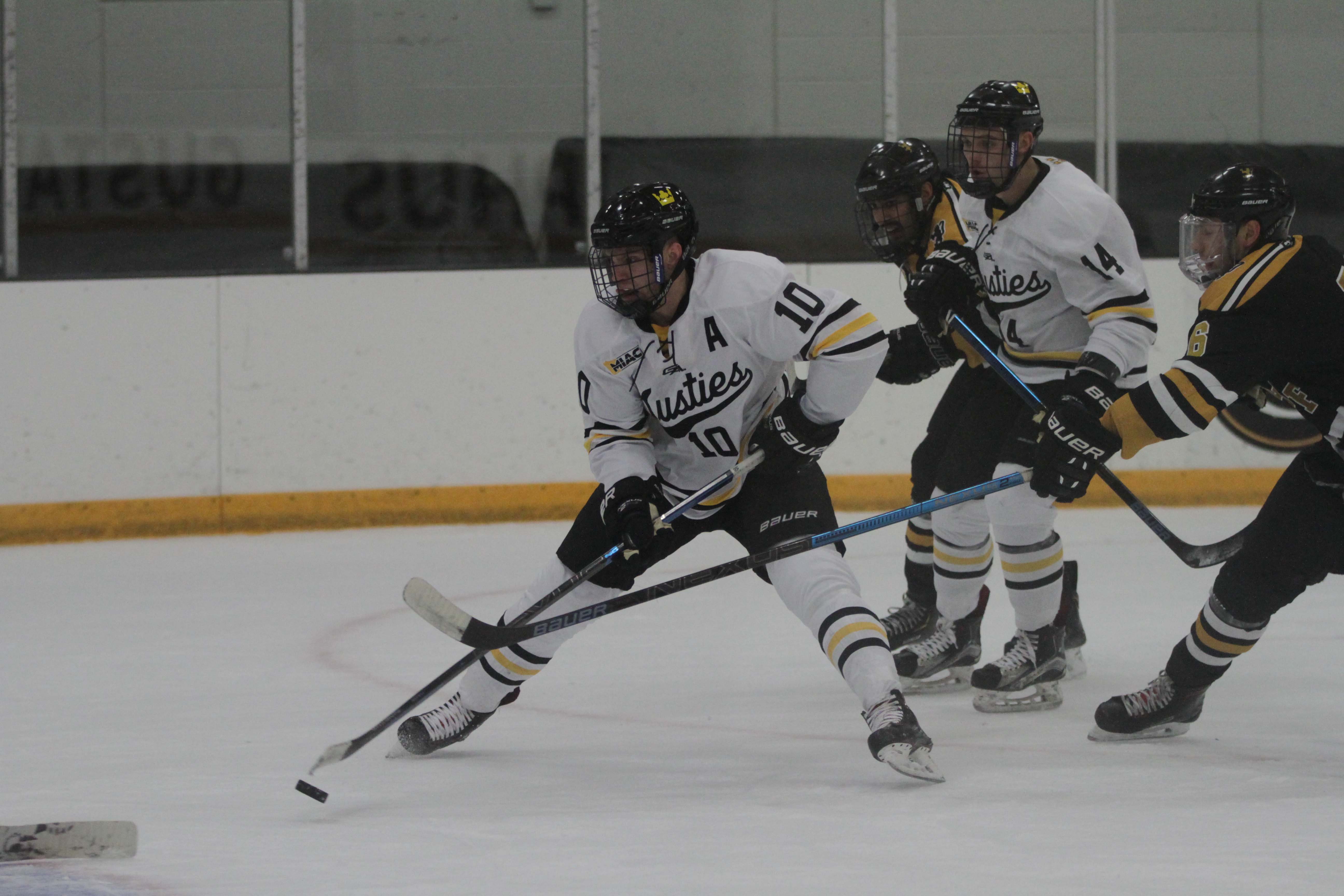Senior Colton Schmidt controls the puck during a game at Don Roberts Ice Rink. After the first few weeks of the 2018-2019 season the Gusties currently hold an overall record of 2-3-1.