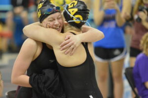 Members of the Women’s Swimming and Diving team celebrate at the MIAC Championships. The team finished second out of 11 teams.