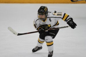 Junior Amelia Vosen skates up the ice during a game this season. Vosen was one of four Gusties named All-Conference.