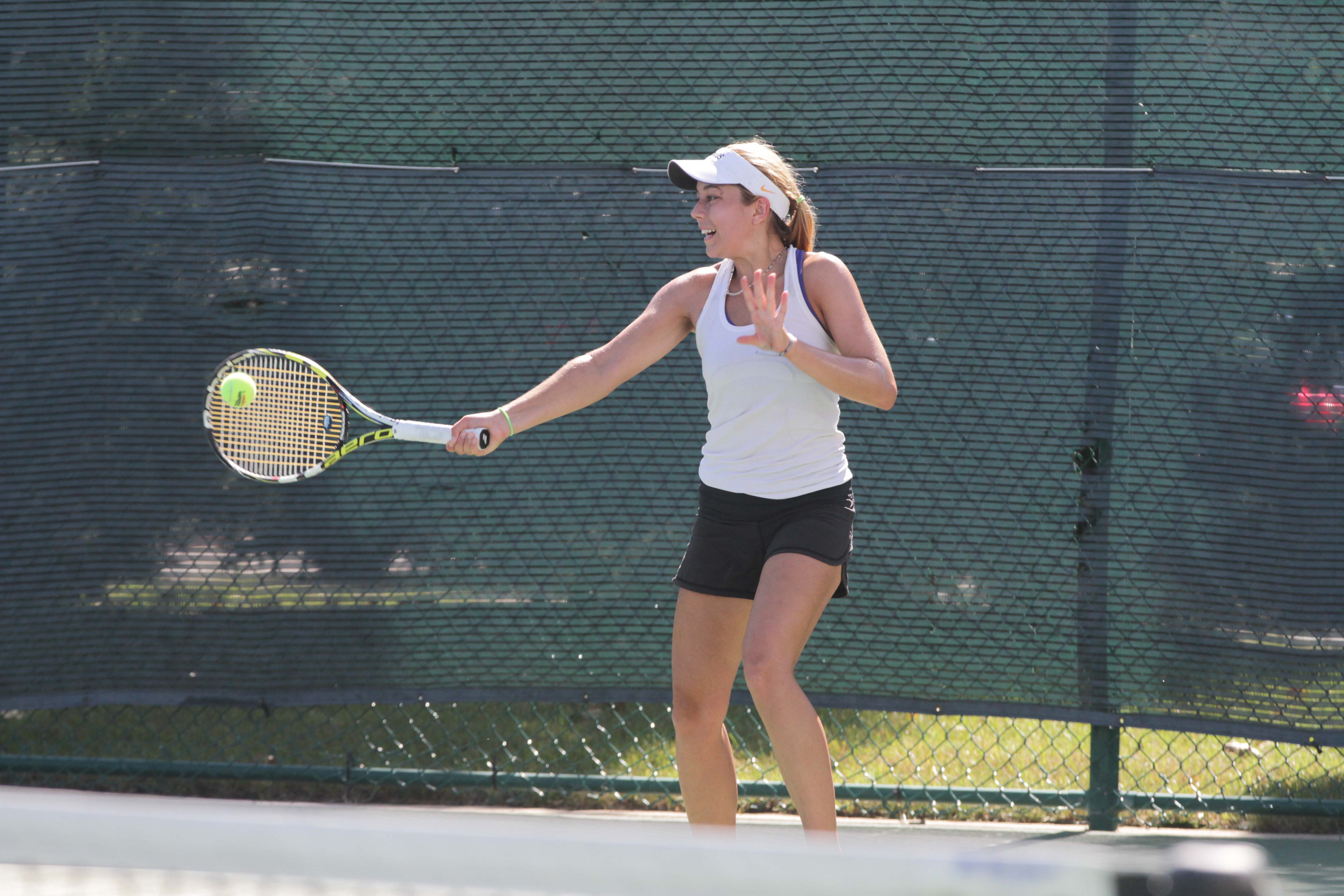 Sophomore Ginger Valenine returns the ball during a singles match. The Gusties currently hold a record of 9-6 in all competitions this spring.