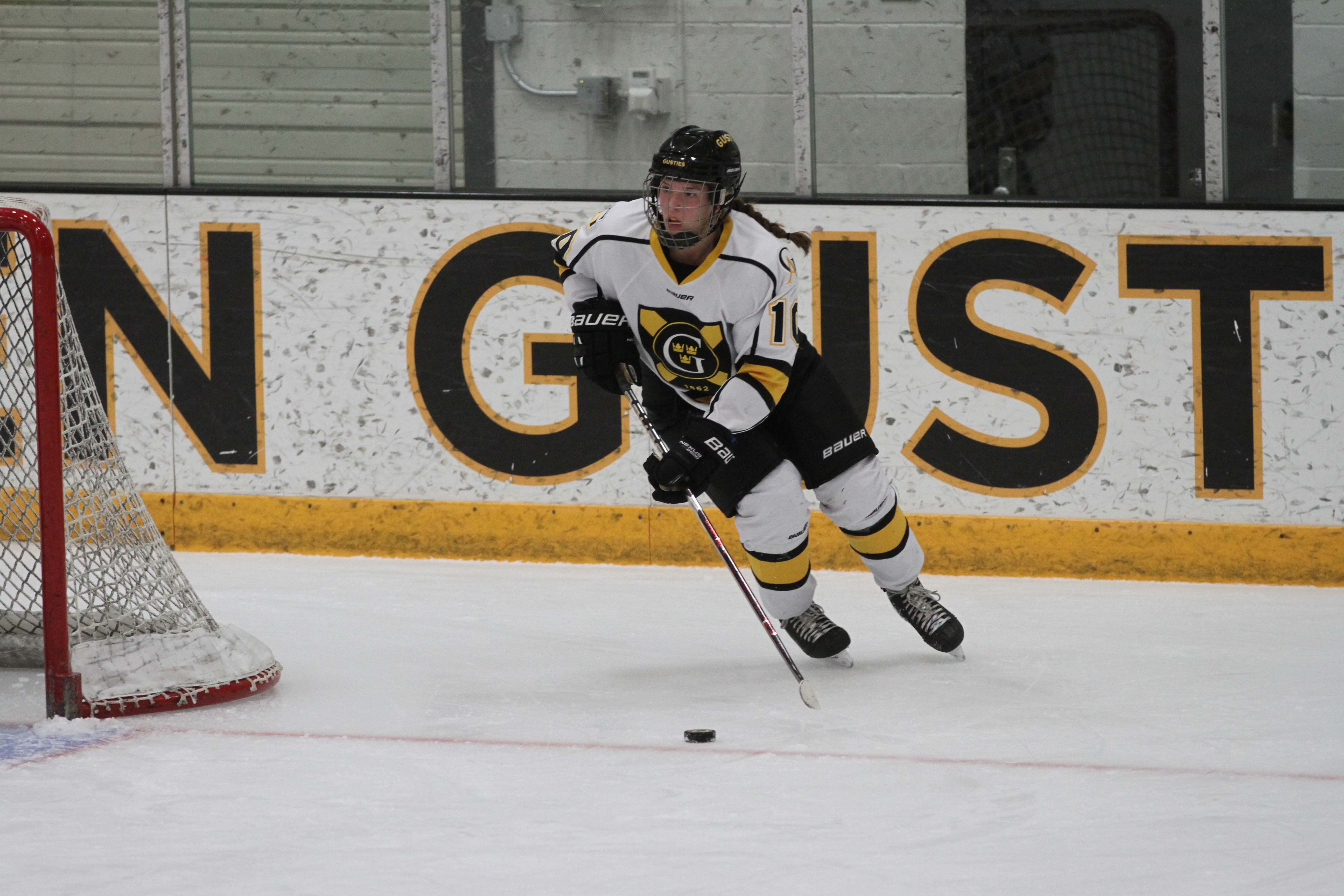 First-year Kayla Vrieze carrries the puck up the ice for the Gusties in a game earlier this season. Vrieze was a first-year standout and named to the MIAC All-Rookie Team this season.