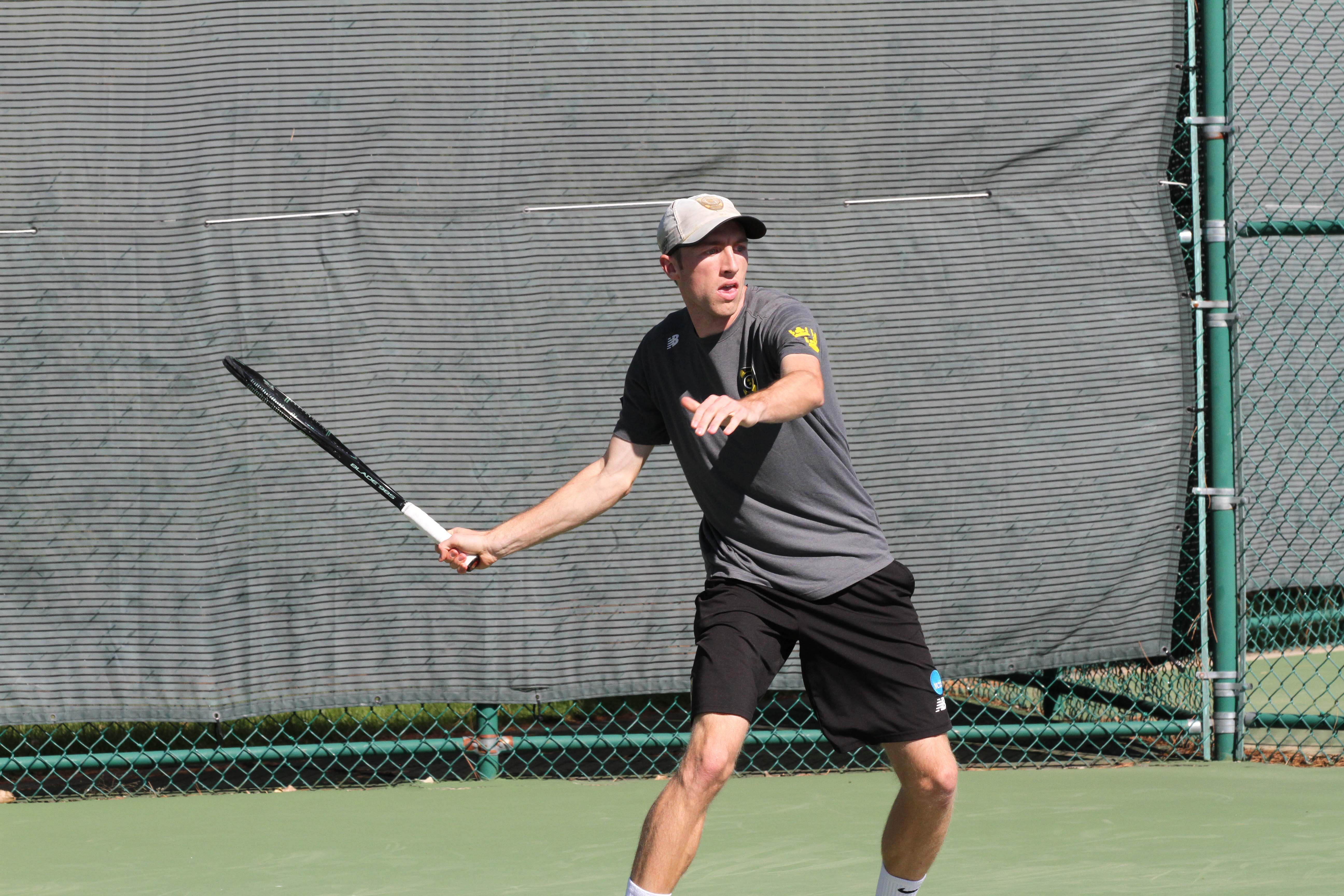 Senior Chase Johnson returns a ball during a match earlier this season. After sweeping conference opponents, St. Olaf and Hamline, the Gusties have improved their record to 8-2.