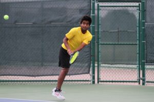 First-year Indraneel Raut takes a backhand swing to return the ball.