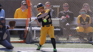 Junior Aly Freeman swings at a pitch during a match last season. The Gusties currently hold a record of 9-5.