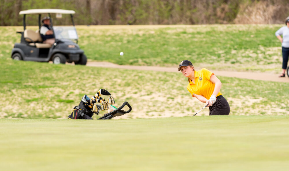 First-year Emily Kratz chips a ball onto the green during the Royal Match Invitational. The Gusties placed fourth out of eight teams at the invite.