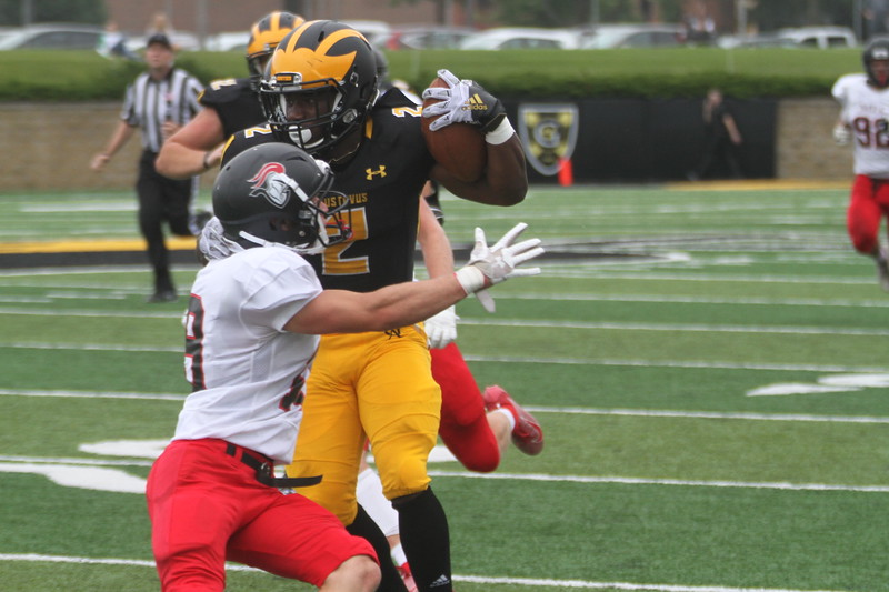 Sophomore David Peal shakes off a Martin Luther defender before running the ball into the endzone for the Gusties, contributing to the team’s 50-19 win.