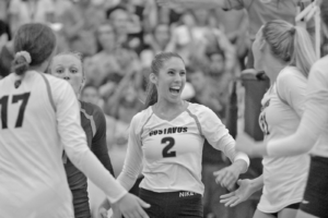 Junior Kate Holtan celebrates with her teammates after winning a point during a match against UM-Morris. 