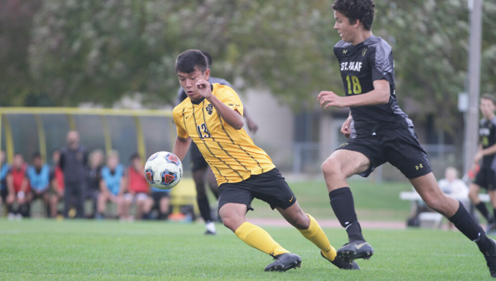 First-year Palden Choesang fights for possession of the ball against a St. Olaf defender. The team currently holds a record of 11-2.