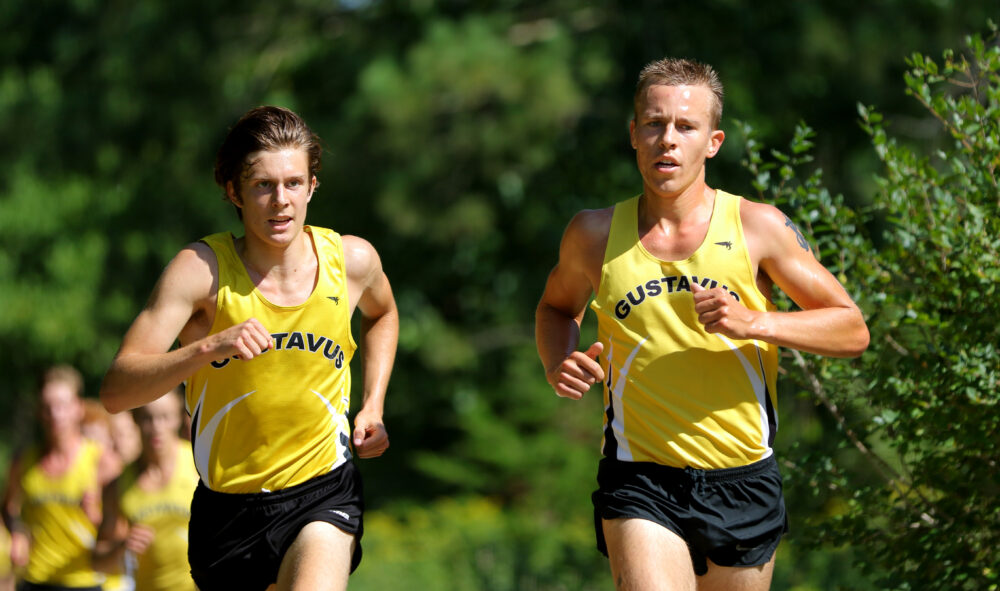 First-year Tucker Wallin and Junior Jeremy Gilbertson maintain their pace during a race earlier this season. Both cross country teams finished in fourth this weekend at the MIAC Championships.
