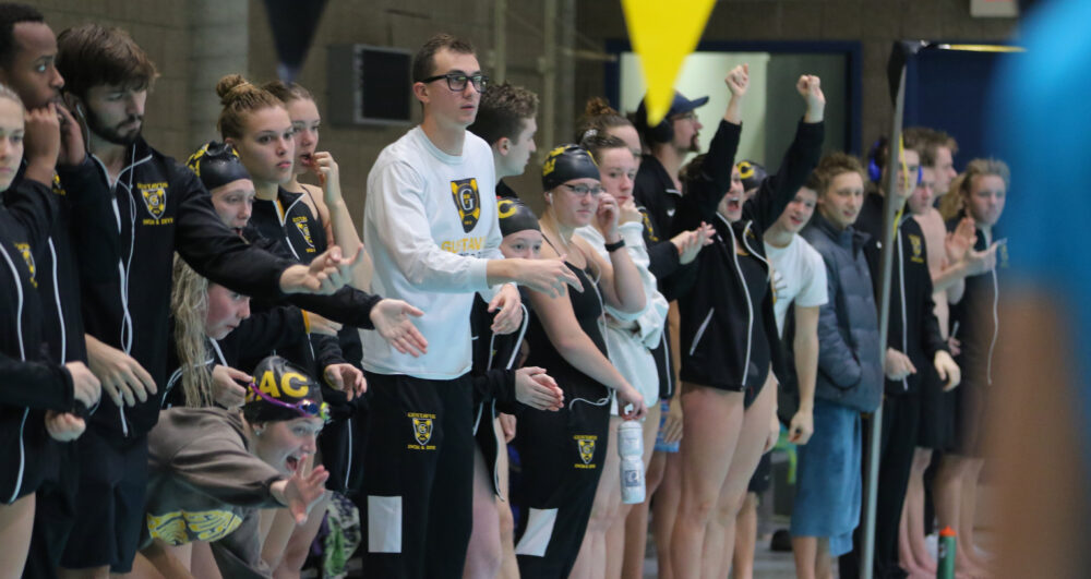 Members of the Gustavus Men’s and Women’s Swimming and Diving teams cheer on their teammates during a meet earlier this season. Both teams took home first at the Grace Goblirsch Invite.