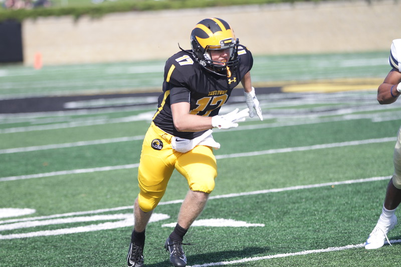 Sophomore Brady Essig begins to run his route during a game earlier this season. The Gusties’ season came to an end with their 49-7 win over St. Olaf.