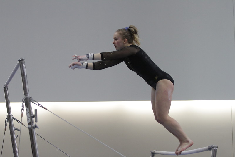 First-year Ashley Goetl competes on the uneven bars for the Gusties during a meet earlier this season. Despite finishing third of three teams the Gusties posted a score of 184.8, the highest this season.