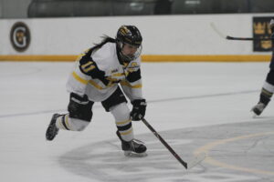 Senior Amelia Vosen races up the ice during a counter attack, hoping to catch her opponents off guard.