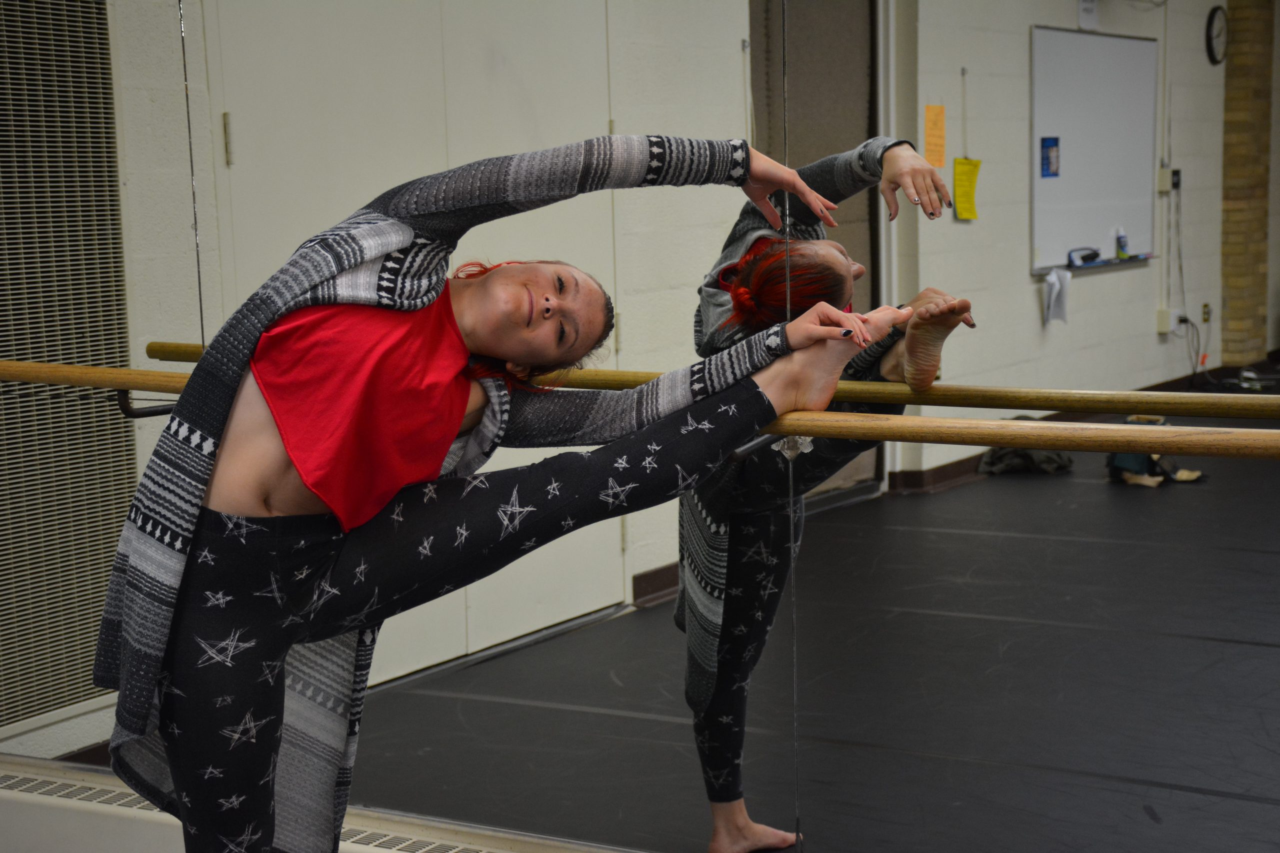 Witte stretches at the barre before her jazz dance class.