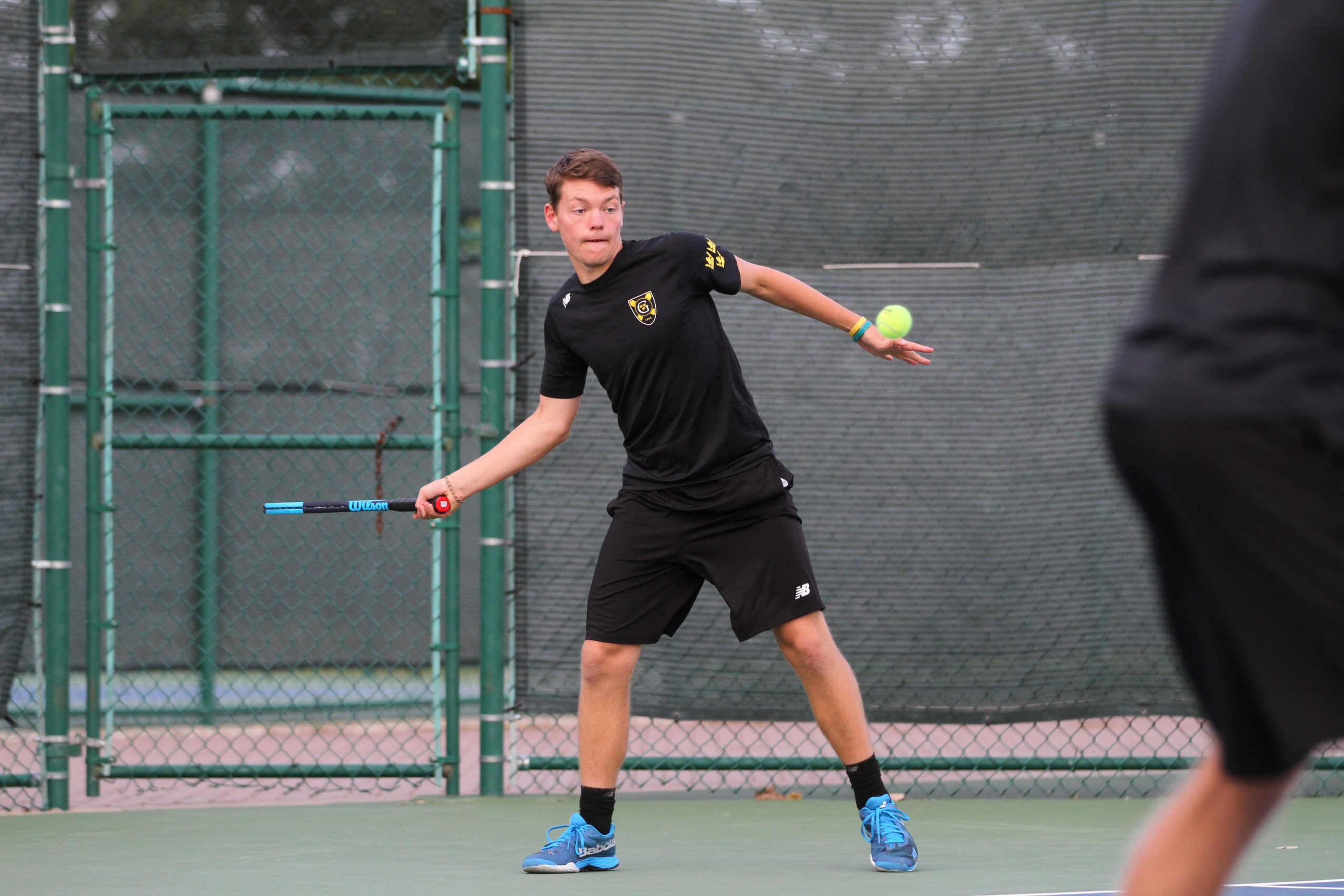 First-year Luke Haddorff returns a serve during a match earlier this season. The team is currently ranked No. 15.