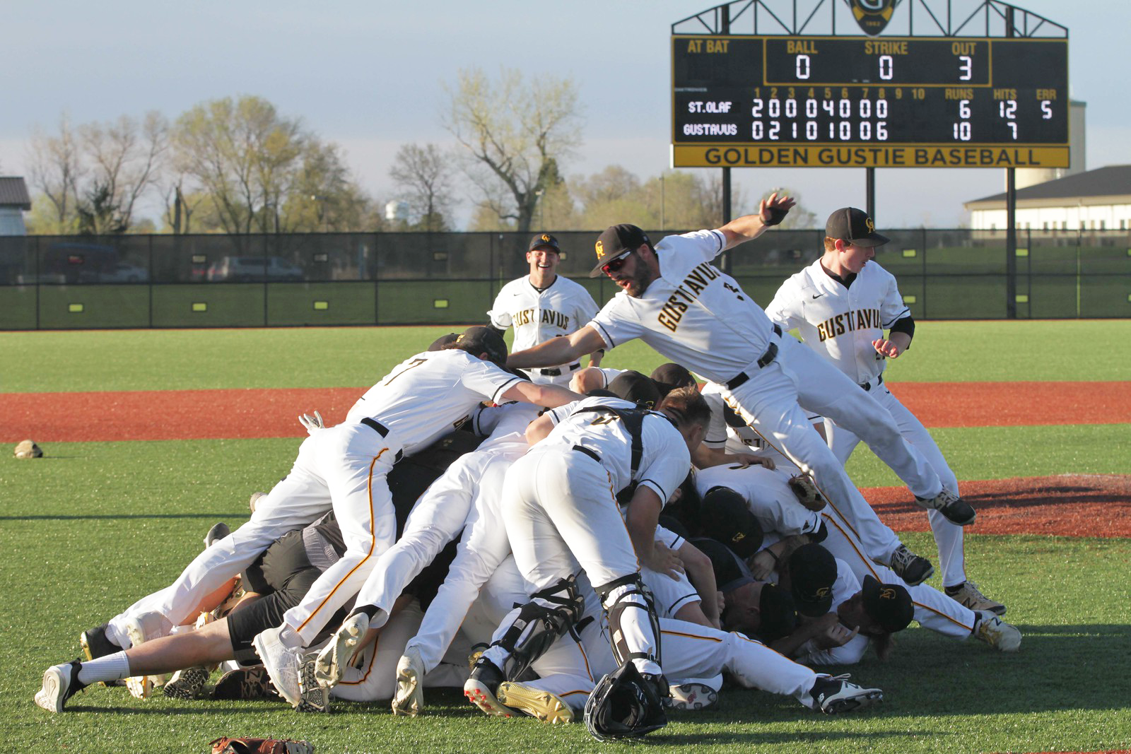 The Gustavus Men’s Baseball team celebrates with a dogpile after claiming the title of this year’s MIAC championship.