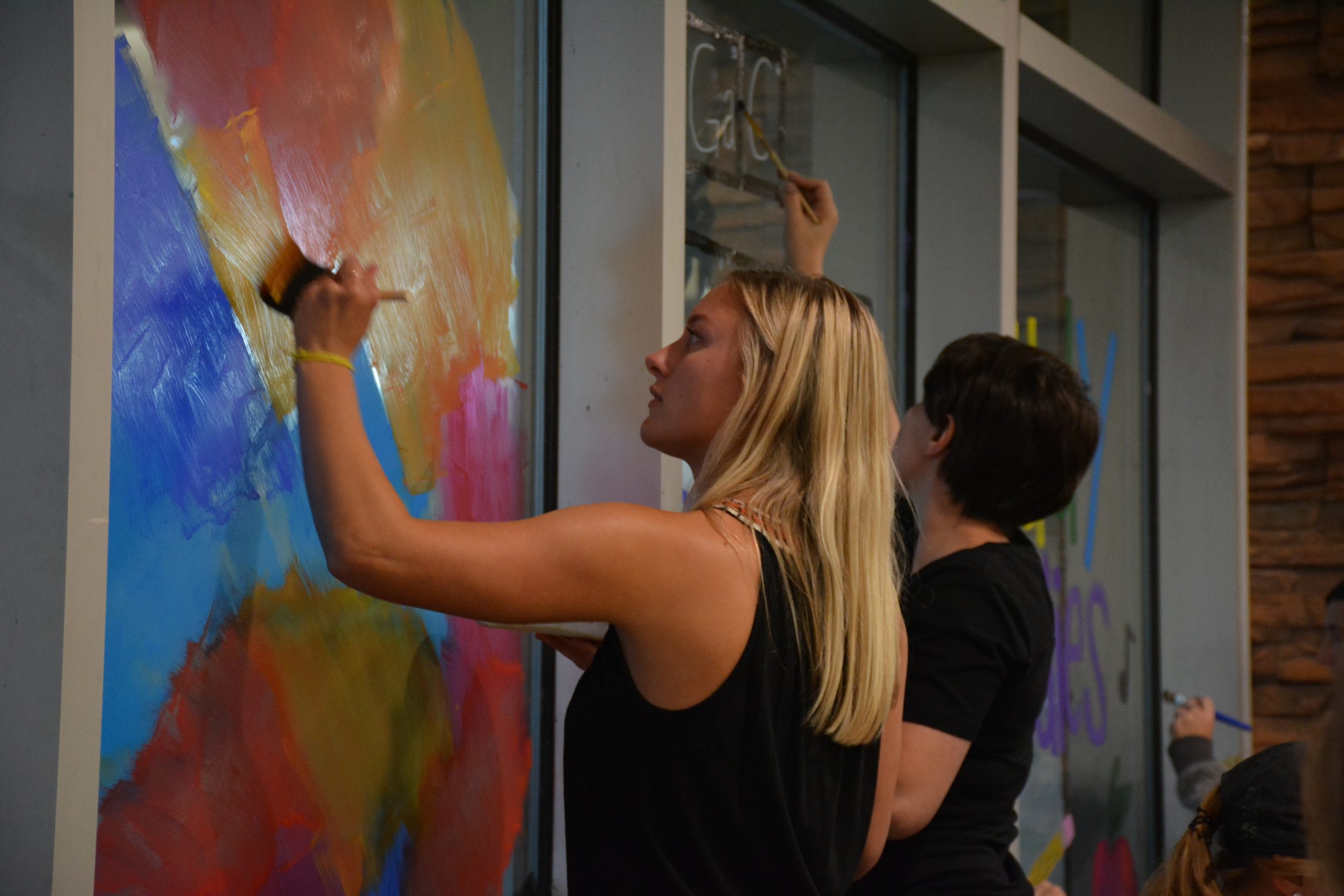 As pictured, student organizations paint the windows in the Evelyn Young Dinning Room.